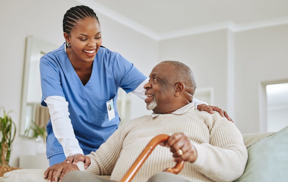 Caregiver providing short-term respite care support to an elderly man at home in the Tampa Area, FL