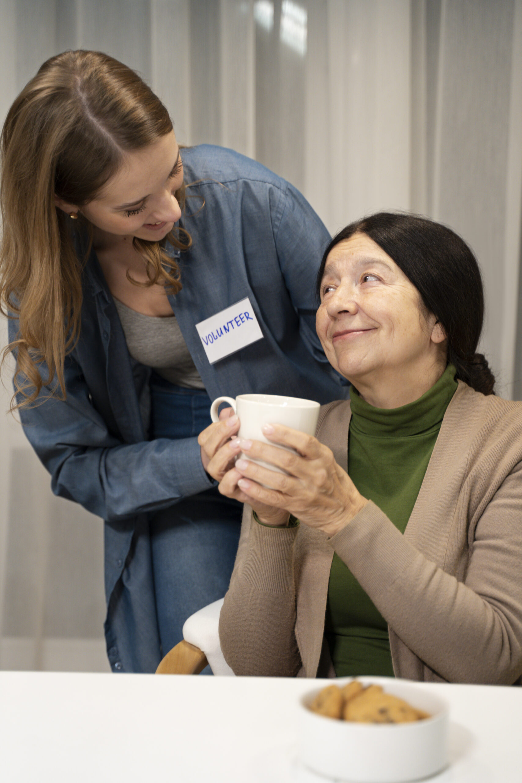 Caregiver assisting a senior woman with companionship and daily support at home in the Tampa Area, FL